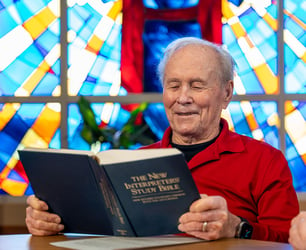 An Immanuel resident reads from a bible in a chapel.